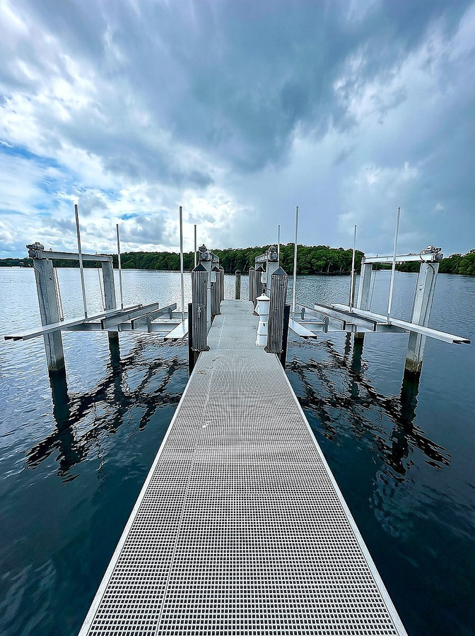 Precision-installed aluminum boat lift system with dock walkway — South Florida waterfront