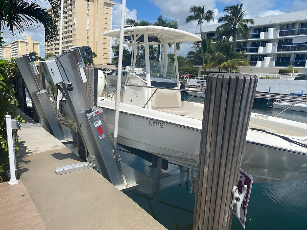 Vertical aluminum boat lift with center console and dual motor control box — South Florida waterfront installation by Contour Marine