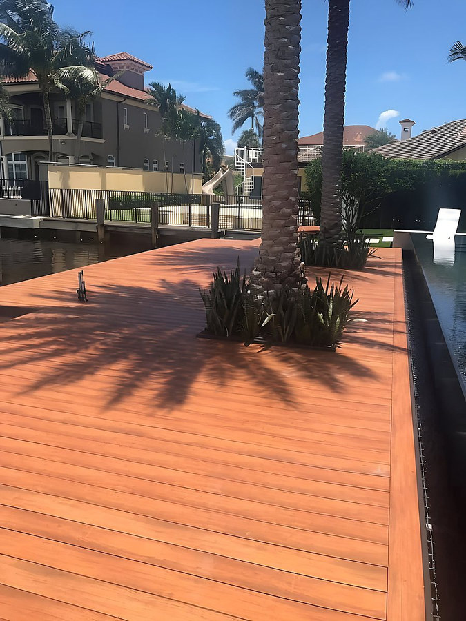 Luxury Ipe hardwood waterfront deck with palm tree and tropical landscaping — South Florida by Contour Marine