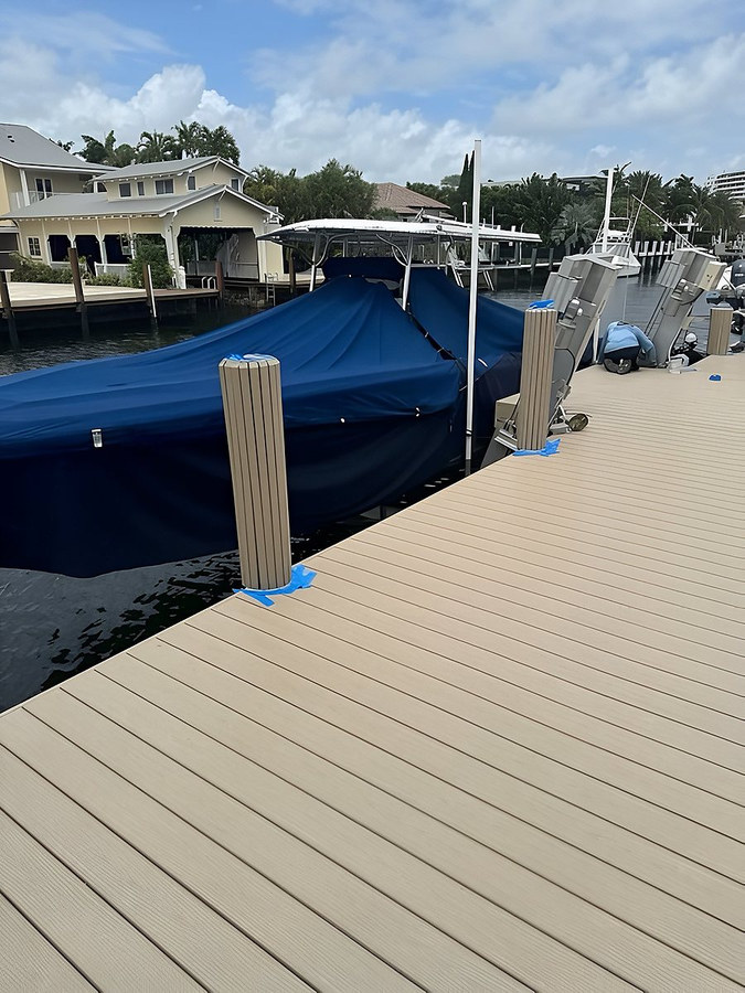 Finished dock platform with boat lift posts and covered boat — South Florida