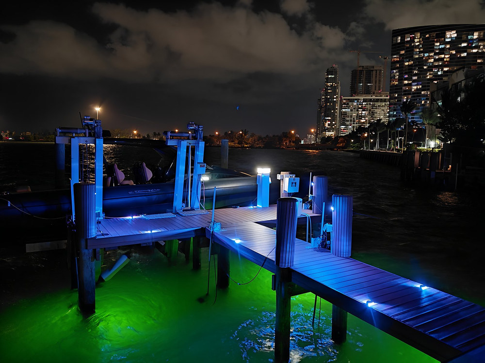 Dock walkway with blue LED lighting and brilliant green underwater glow — South Florida