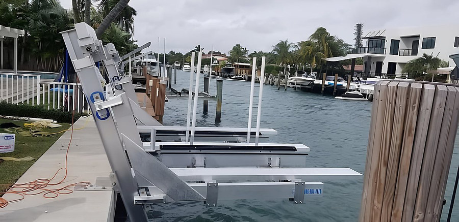 Deco double jet ski lift aluminum frame being installed — side view along South Florida canal